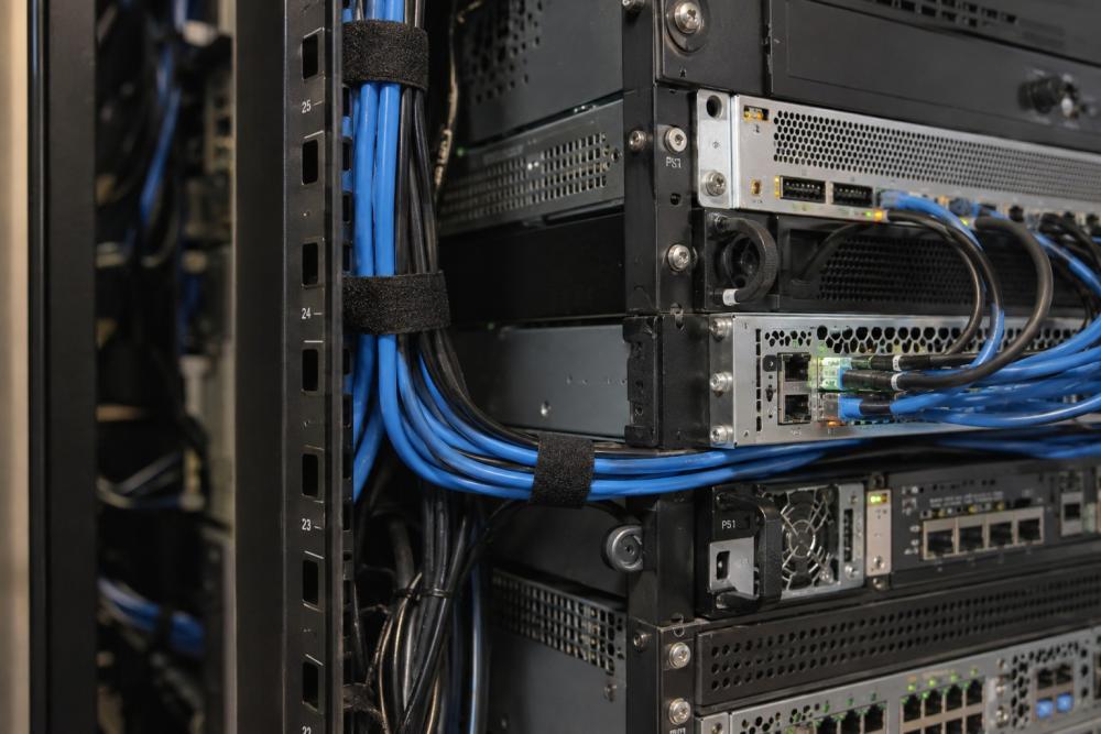 Cables routed along equipment with reusable hook-and-loop ties