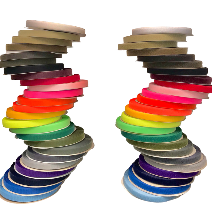 Two identically ordered, S-curved stacks of colorful hook and loop fastener tape rolls.