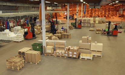 Industrial warehouse featuring pallets and shipping boxes for storage and logistics