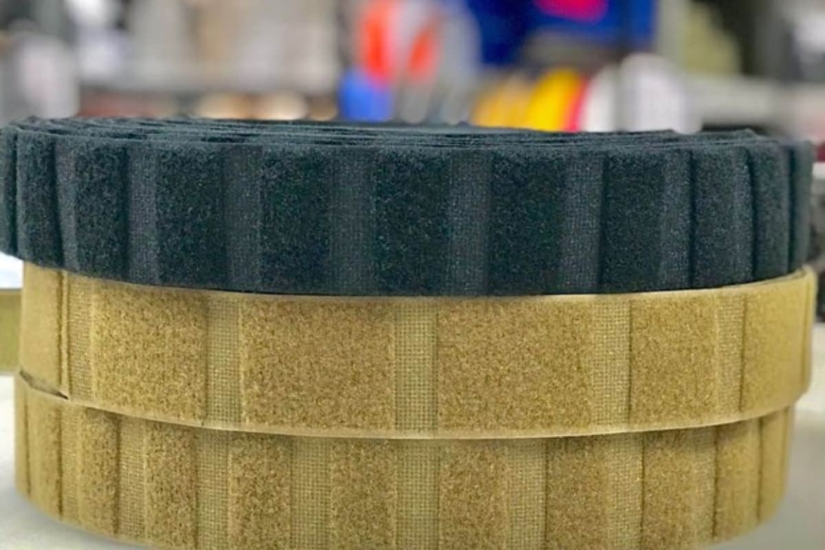 Rolls of hook and loop straps showing distinct, evenly spaced rectangular sections bonded together via ultrasonic welding.